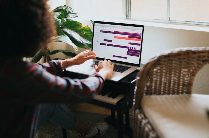  A woman seated at a desk with a laptop and keyboard, engaged in strategic decision making using AI insights.